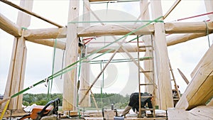 Construction workers building a two story residential house outdoors on a summer time. Clip. Carpenters at work with the