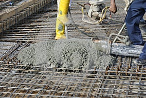 Construction Workers casting concrete using concrete hose