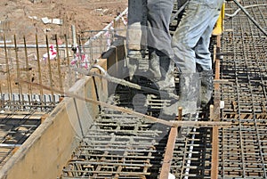 Construction Workers casting concrete using concrete hose