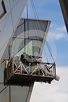 Construction workers in the check outer wall glass