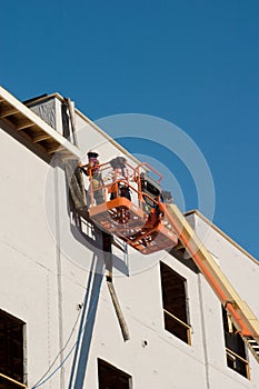Construction Workers On A Cherry Picker photo