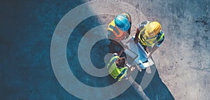 The construction workers collaborating on project plans at a job site. AI generated image