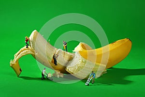 Construction Workers in Conceptual Food Imagery With Banana photo