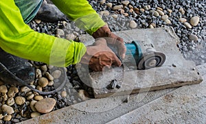 Construction workers cut bricks