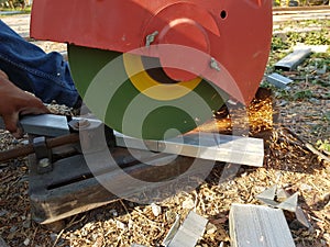 Construction workers cut steel with a circular saw. Make a spark