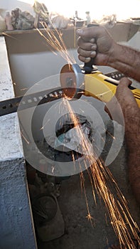 Construction workers cutting steel for fabrication work at a under construction building