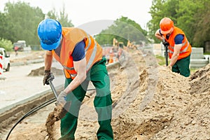 Construction workers digging photo