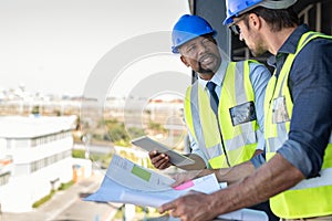 Construction workers discussing blueprint