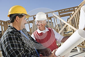 Construction Workers Discussing At Site