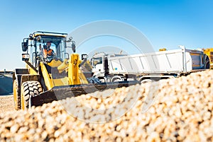 Construction workers doing earthworks with wheel loader photo