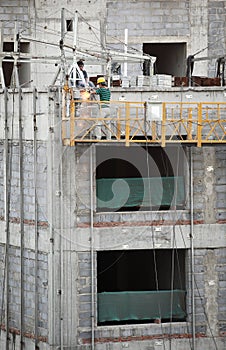 Construction workers on elevator