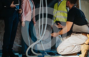 Construction workers and engineers discussing site plans inside a building under renovation