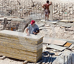 Construction workers fabricating ground beam