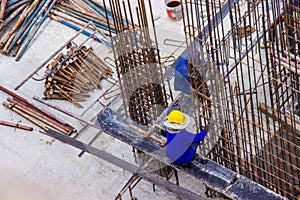 Construction workers fabricating large steel bar reinforcement bar at the in construction area building site