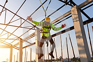 Construction workers fall from a height but have safety to help. Concept of preventing danger from heights with Safety on the photo