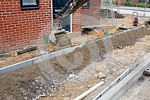 Construction workers finishing construction of new residential house and installing footpath