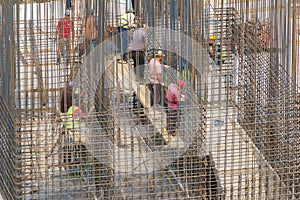 Construction workers fixing reinforcing steel bars