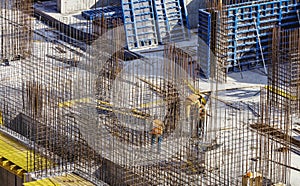 Construction workers install formwork and iron rebars or reinforcing bar for reinforced concrete partitions at the construction