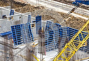 Construction workers install formwork and iron rebars or reinforcing bar for reinforced concrete partitions at the construction