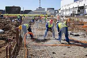 Construction workers during installation of steel gratings for the foundation of a building. Sao Paulo, Brazil