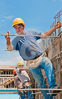 Construction workers installing formwork frames