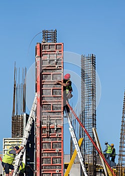 Construction workers installing formwork on site