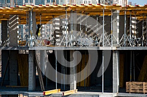 Construction workers installing mounting horizontal formwork on the building construction site.