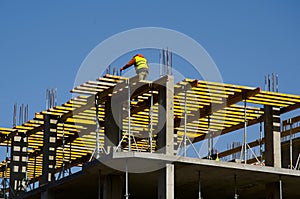 Construction workers installing mounting horizontal formwork on the building construction site.