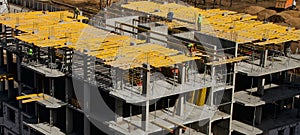 Construction workers installing mounting horizontal formwork on