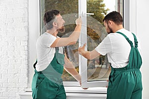 Construction workers installing new window