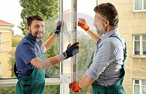 Construction workers installing new window