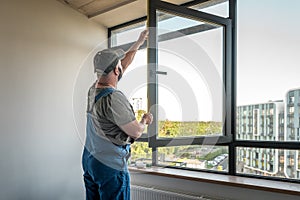 Construction workers installing new window in apartement photo