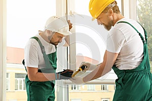 Construction workers installing new window