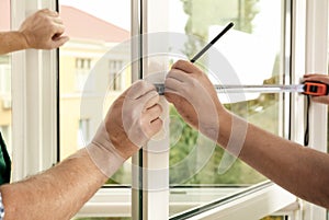 Construction workers installing new window