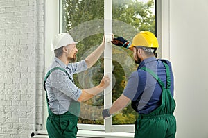 Construction workers installing new window
