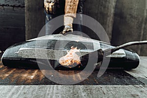 Construction workers insulating rooftop with bituminous membrane photo