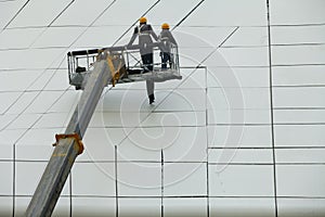 Construction workers in mobile hydraulic construction platform
