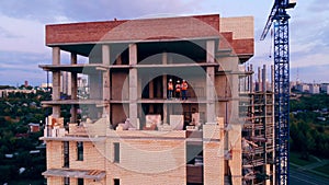 Construction workers in the multistory building in progress