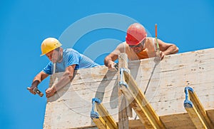 Construction workers nailing formwork in place photo