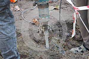 Workers using a jackhammer in a construction area