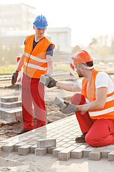 Construction workers paving street