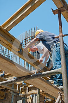 Construction workers placing formwork beams photo