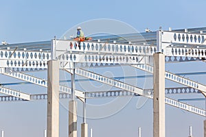 Construction Workers Rigging High Beams Columns
