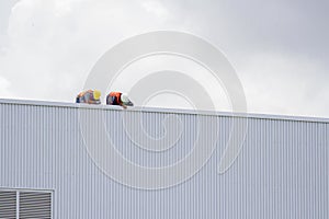 Construction workers on the roof of the building