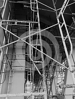 Construction workers on a scaffold. Black and white