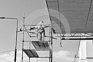 Construction workers on a scaffold. Black and white.