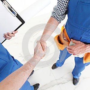 Construction workers shaking hands