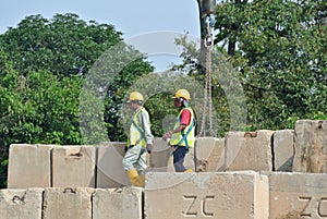 Construction workers stacking the maintain load test block at the construction site.