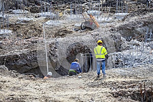 Construction workers and  steel rebar reinforcement