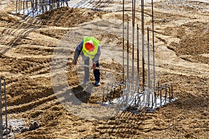 Construction workers and steel rebar reinforcement for poles